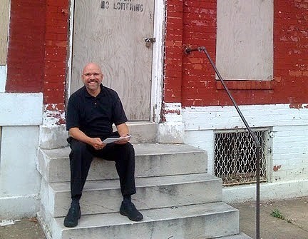 Steward Pickett sitting on staircase outside a house